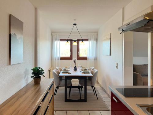 a kitchen and dining room with a table and chairs at Apartment mit Titisee-Blick - Villa Hubertus in Feldberg