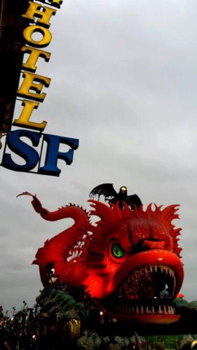 a large red dragon statue in front of a sign at Hotel San Francisco in Viareggio