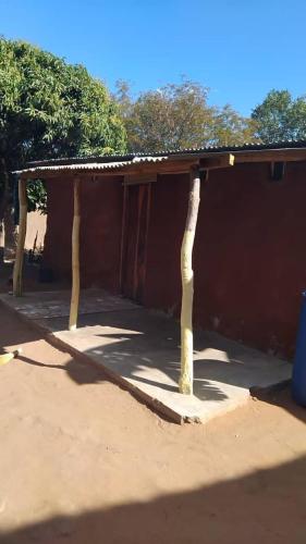 a small building with a roof on top of it at Muke Village Guest House in Livingstone