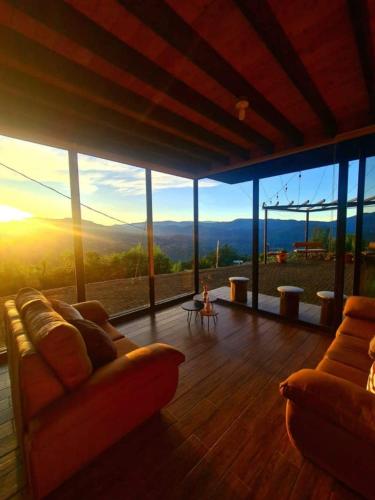 a living room with a view of the mountains at Glamping Los tucanes in San José