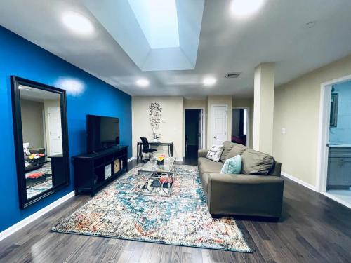 a living room with a couch and a tv at Cozy Beautiful 2BD Apt in Center City in Philadelphia