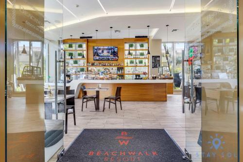 a restaurant with a counter and tables and chairs at Amazing Studio with Balcony & Pool in Hallandale Beach
