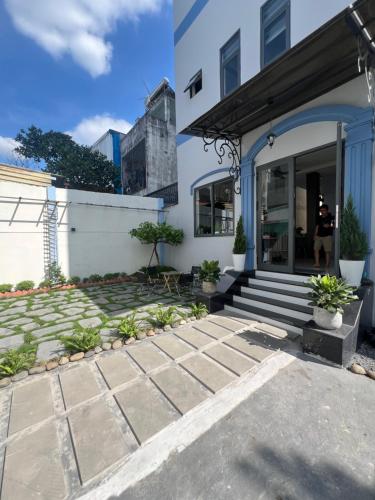 a house with a stone walkway in front at The Sun Hotel in Long Bình