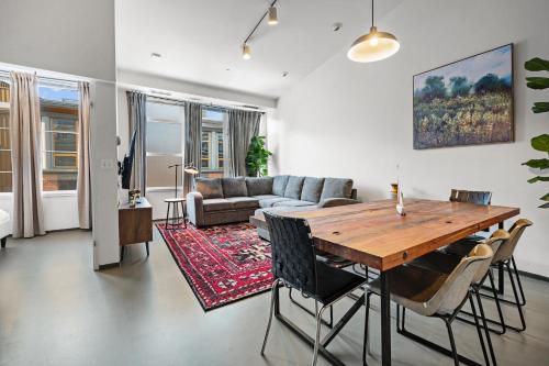 a living room with a table and a couch at Furnished Loft Style Apartment in Southend in Boston