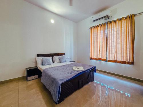 a bedroom with a bed and a window at Private 3BHK Villa with Indoor Pool in Chengalpattu