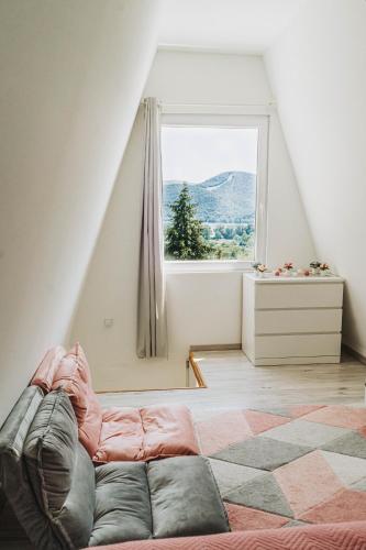 a room with a couch in front of a window at Ringat-Lak Panoramic hideout just for 2 in Nagymaros