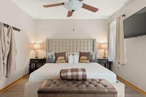 a bedroom with a large bed with a ceiling fan at Love Lace Retreat in Albrightsville