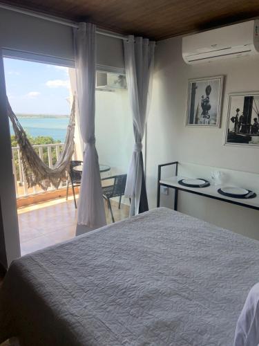 a bedroom with a bed and a view of the ocean at Pousada e Restaurante Manah in Propriá