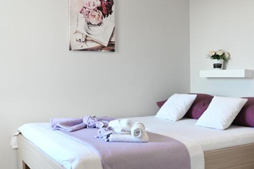 a bedroom with a bed with stuffed animals on it at Vila Maričić in Sveti Petar