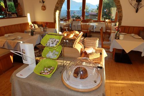 a table in a restaurant with a plate of food at Pension Noella in Sankt Johann in Tirol