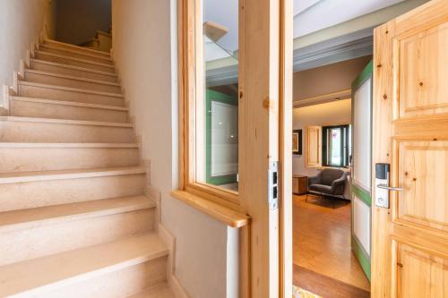 a hallway with stairs leading to a living room at Vila Origens Boutique Hotel Albufeira – Adults Only in Albufeira