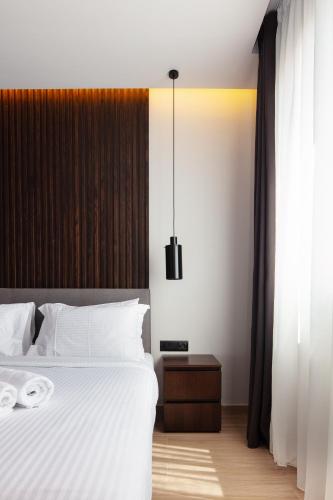 a bedroom with a large white bed and a window at Athens Tower in Athens