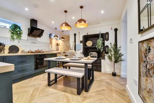 a kitchen with a dining table and a stove at The Oven House-Wyndale Living - Malvern Hills in Great Malvern