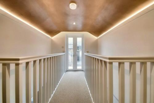 a hallway with white walls and a ceiling at The Oven House-Wyndale Living - Malvern Hills in Great Malvern