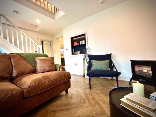 a living room with a couch and a chair at The Oven House-Wyndale Living - Malvern Hills in Great Malvern