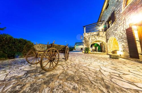 a horse drawn carriage parked in front of a building at Villa Poseidon Residence in Skinária