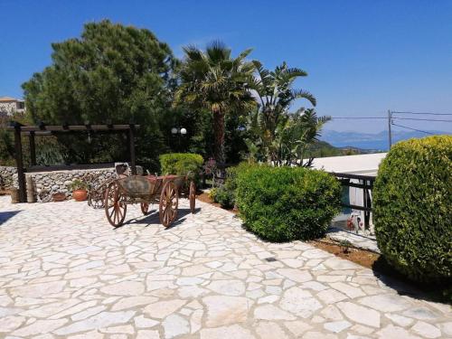 a horse drawn carriage sitting on a stone patio at Villa Poseidon Residence in Skinária