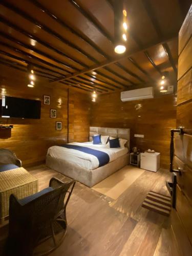 a bedroom with a large bed with blue pillows at Lemonwood cottage in North Lakhimpur