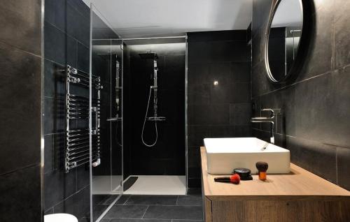 a bathroom with a sink and a shower and a sink at Chalet Le Prariand - Megève in Megève