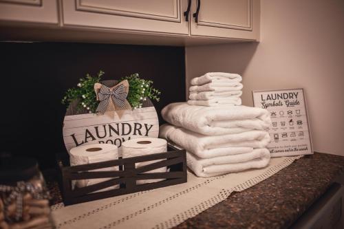 a pile of towels on a counter with a calendar at Villa Experience Nature Le Nid in Saint-Irénée