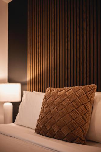 a bedroom with a bed with a pillow and a lamp at Villa Experience Nature Le Nid in Saint-Irénée