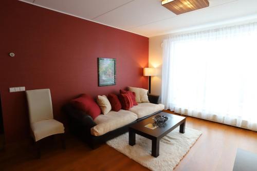a living room with a couch and a table at Ujula Apartment in Tartu