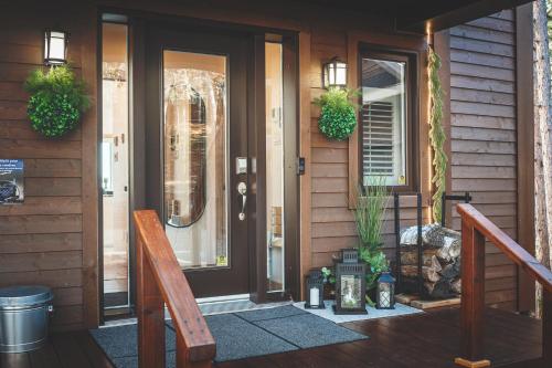 a front door of a house with plants on it at Villa Experience Nature Le Nid in Saint-Irénée