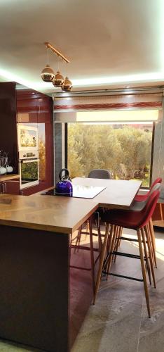 a kitchen with a table and chairs and a window at Equi Palace & SPA Near Aeroport in Berrechid