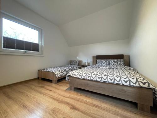 a bedroom with two beds and a window at Wiślańska Dolina in Wisła