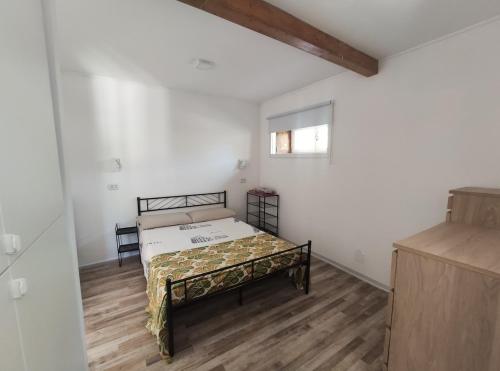 a bedroom with a bed in the corner of a room at Italia Highland Retreat in Abruzzo in Verrecchie