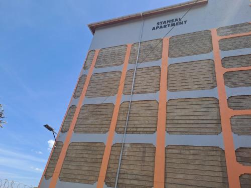 a building with a sign on the side of it at Stansal apartments in Kikuyu