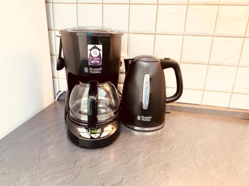 a coffee maker and a coffee pot on a counter at Gemütliches Apartment mit Fernblick Kamin Balkon in Zwiesel
