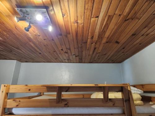 a room with a table and a wooden ceiling at Logement sympas à Saintes in Saintes