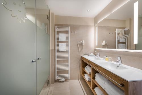 a bathroom with a sink and a mirror at Familienhotel Sonngastein in Bad Gastein