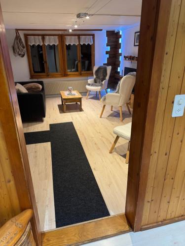 a view of a living room with a couch and chairs at Enzian 4 Zi Ferienwohnung in Landhaus in Frutigen