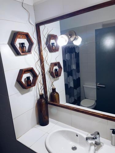a bathroom with a sink and a mirror at PDLA Apartment in Mendoza