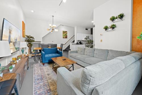 a living room with a couch and a table at Furnished Loft Style Apartment in Southend in Boston