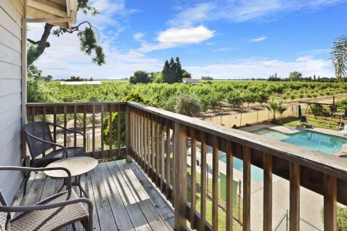 a balcony with chairs and a view of a vineyard at Wine Country Oasis Private Pool & Spa in Acampo