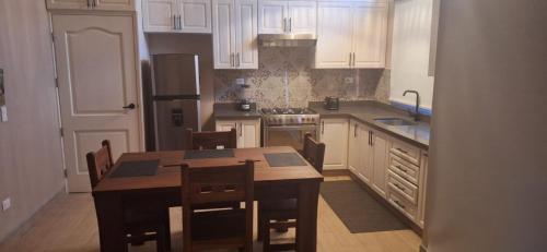 a kitchen with a table and chairs and a kitchen with white cabinets at Tiny Home Villa - T8 in San Diego