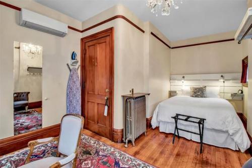 a bedroom with a bed and a chair in it at InnBuffalo Off Elmwood in Buffalo