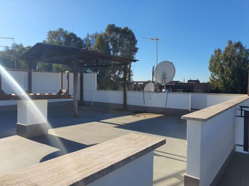 a rooftop with a picnic table on a roof at Il sole di Roma in Casal Palocco