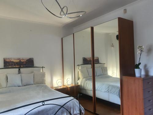a bedroom with a mirror and a bed and a dresser at Il sole di Roma in Casal Palocco