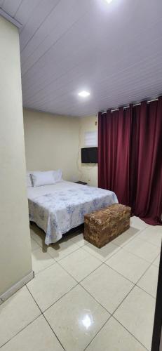 a bedroom with a bed with purple curtains at Casa Lory in Angra dos Reis