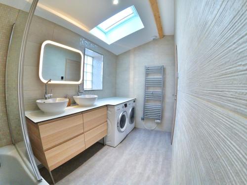 une salle de bain avec un lavabo et une machine à laver dans l'établissement UnSejourAMetz - LeGrandJeu - 14 pers - 4 garages, à Metz