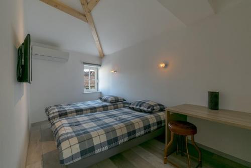 une petite chambre avec un lit et un bureau dans l'établissement UnSejourAMetz - LeGrandJeu - 14 pers - 4 garages, à Metz