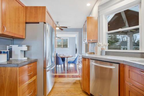 a kitchen with a stainless steel refrigerator and a dining room at Spacious 5 BR house - 5 Min Walk to N-MC Stadium in Annapolis