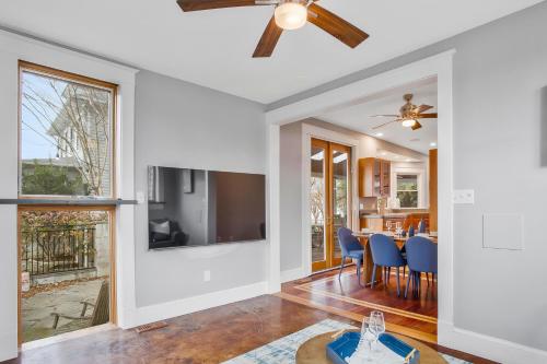 a dining room and living room with a ceiling fan at Spacious 5 BR house - 5 Min Walk to N-MC Stadium in Annapolis