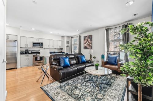 a living room with a couch and a table at Beautiful 2BR in Southend Boston in Boston