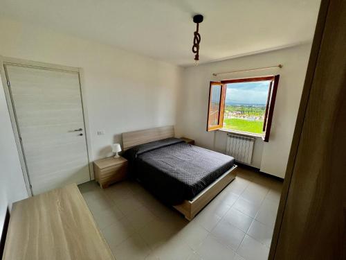 a small bedroom with a bed and a window at Appartamento La Rondine in Pignataro Maggiore