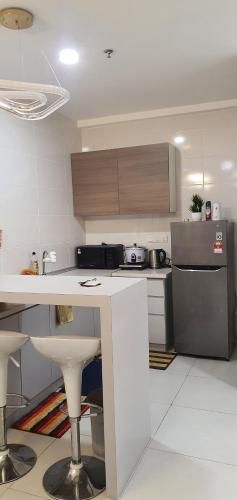 a kitchen with a white counter top in a kitchen at Ayesha Metrocity Staycation N-02 & N-5-03 in Kuching
